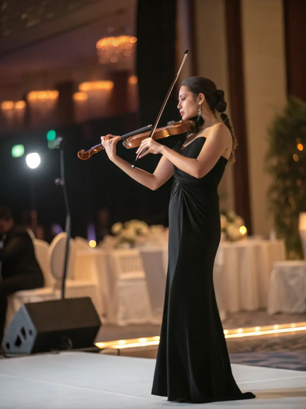 A photograph of an intermediate violin student performing a solo piece during a Harmony Strings recital.